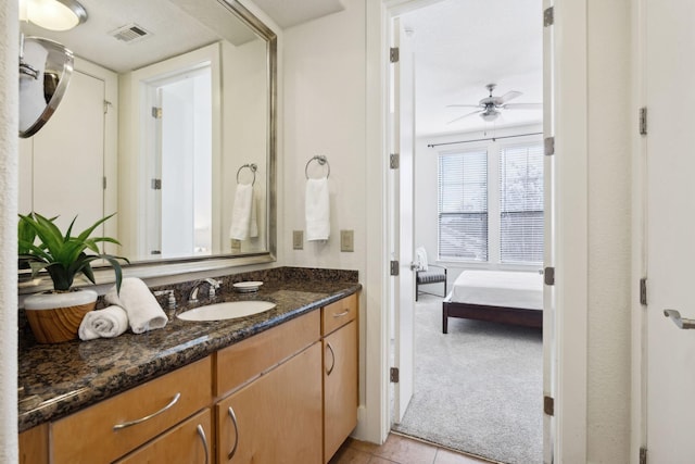 ensuite bathroom with vanity, a ceiling fan, visible vents, ensuite bathroom, and tile patterned floors