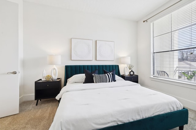 bedroom with baseboards and carpet floors