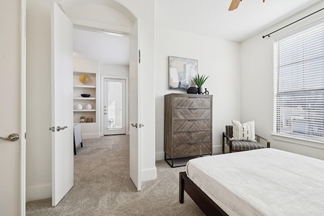 carpeted bedroom with baseboards and ceiling fan