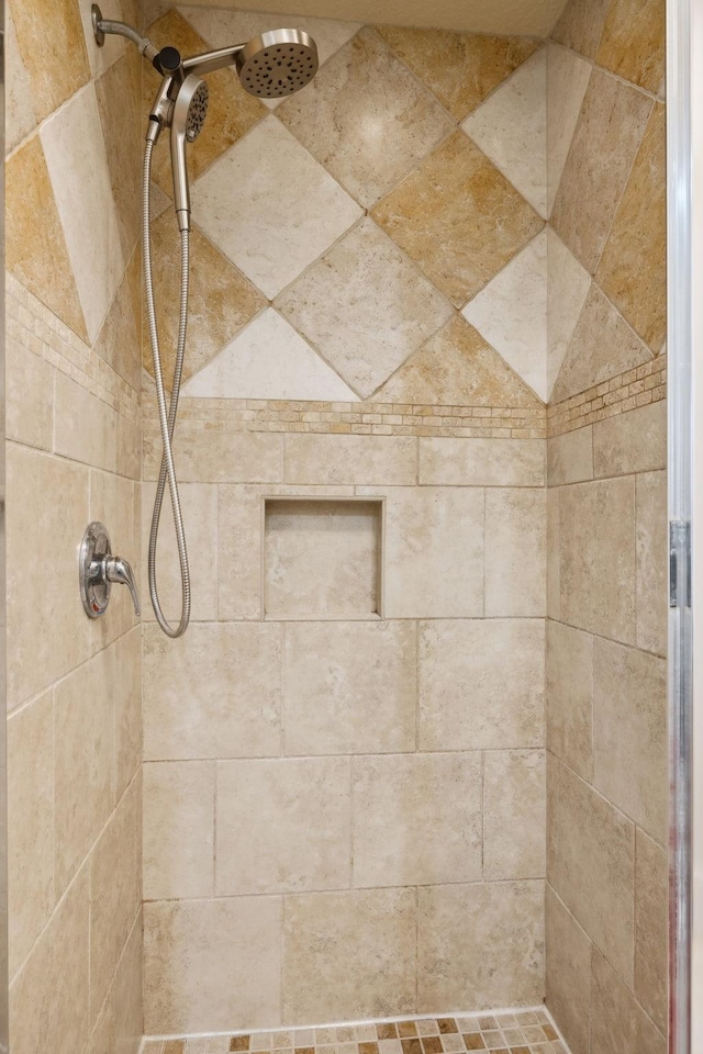 full bath with tiled shower