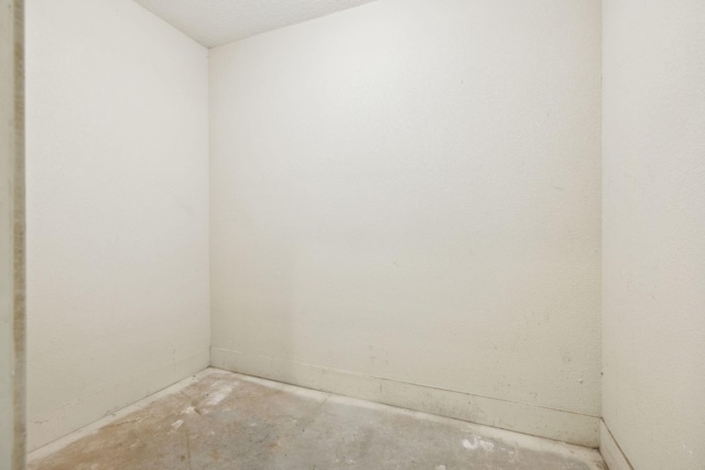 spare room with unfinished concrete flooring