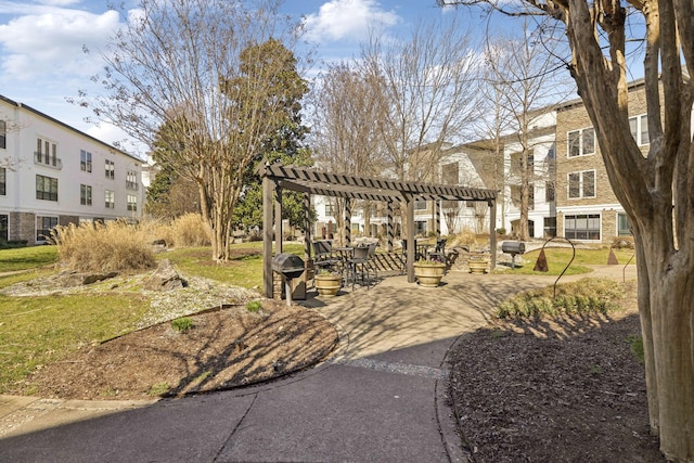 surrounding community with a patio area and a pergola