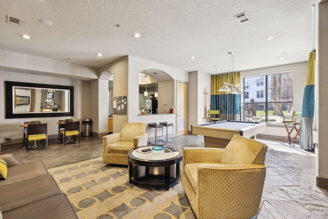 living room featuring visible vents, billiards, stone tile flooring, recessed lighting, and arched walkways