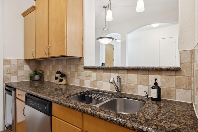 kitchen featuring arched walkways, decorative backsplash, dishwasher, and a sink