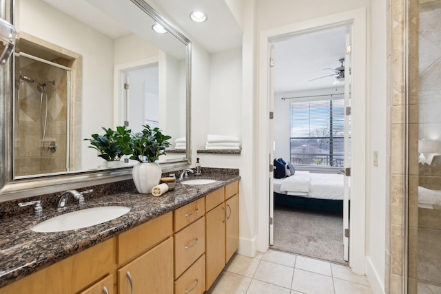 ensuite bathroom with a sink, a stall shower, ensuite bathroom, and tile patterned flooring