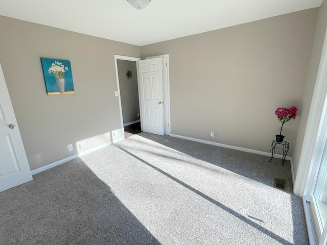 unfurnished bedroom with visible vents, baseboards, and carpet flooring