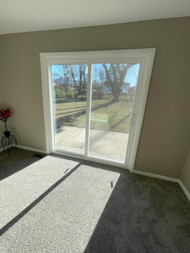 interior space with carpet flooring and baseboards