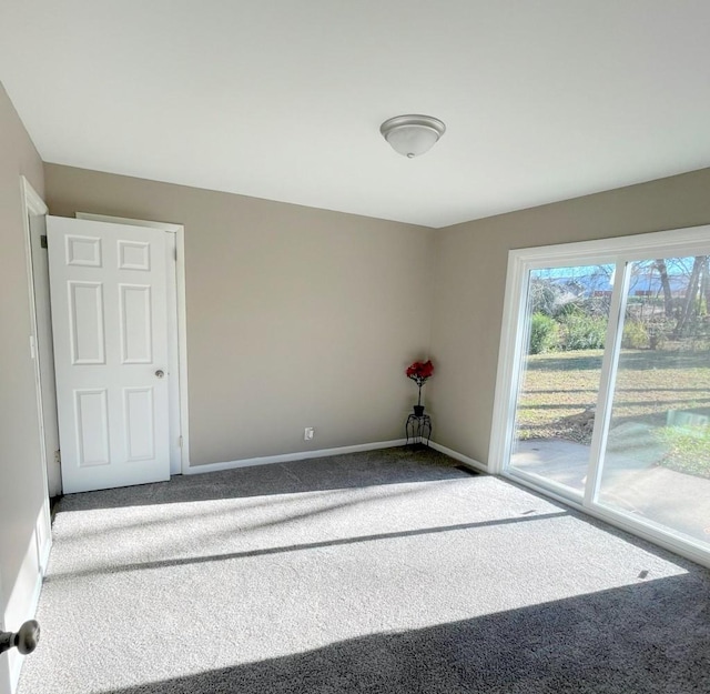 carpeted spare room with baseboards