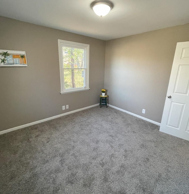 carpeted spare room with baseboards