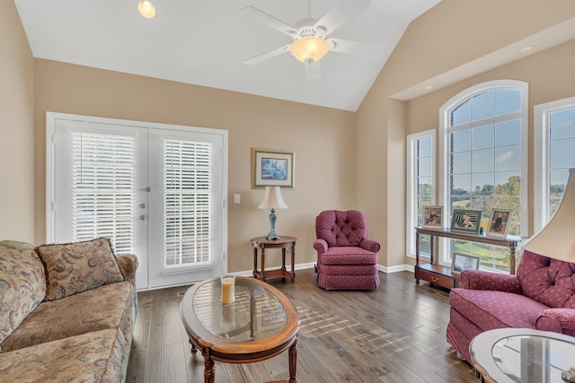 living area featuring a wealth of natural light, wood finished floors, ceiling fan, and vaulted ceiling