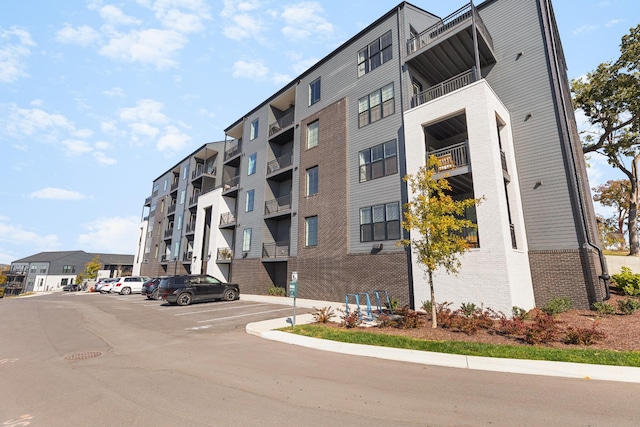 view of building exterior featuring uncovered parking