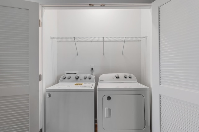 clothes washing area featuring washing machine and dryer and laundry area