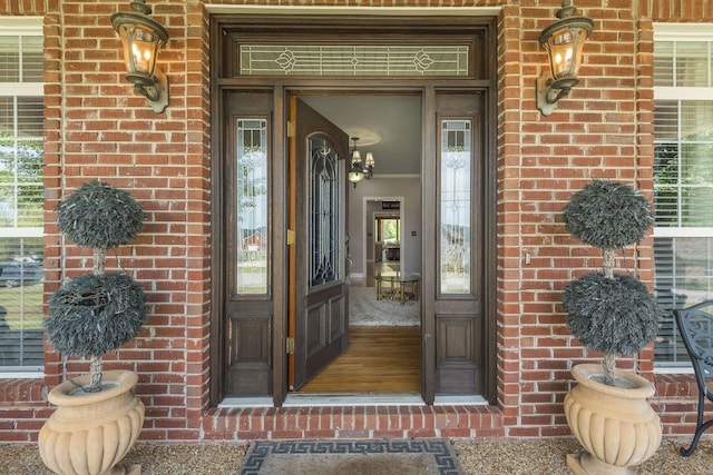 doorway to property featuring brick siding