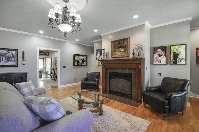 living area with a high end fireplace, an inviting chandelier, baseboards, and light wood finished floors