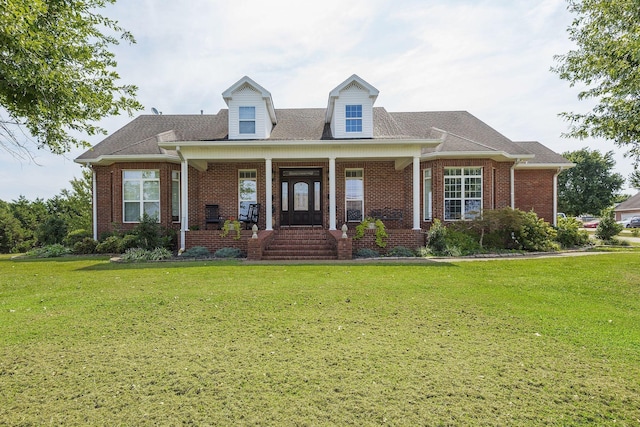 cape cod home with a front yard, covered porch, and brick siding