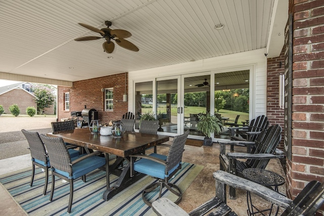 view of patio / terrace with outdoor dining area, a ceiling fan, and french doors