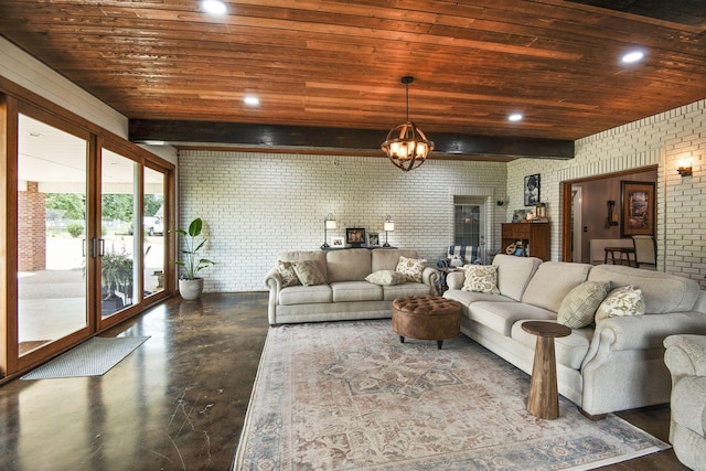 living area featuring wood ceiling, concrete flooring, brick wall, and a chandelier