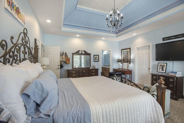 carpeted bedroom featuring crown molding, a chandelier, recessed lighting, ensuite bathroom, and a raised ceiling