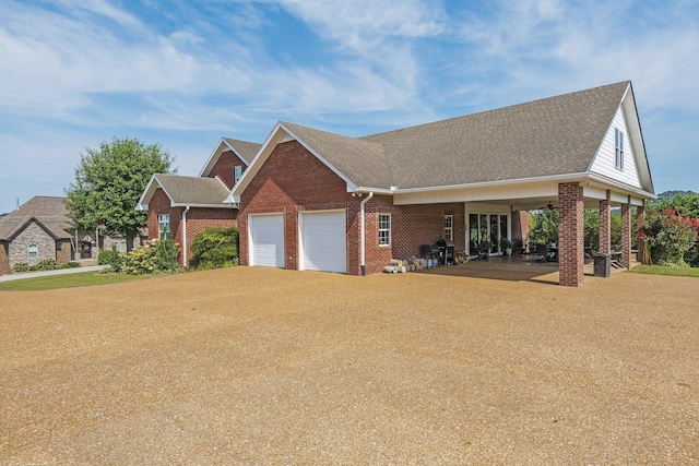 view of front facade featuring brick siding, an attached garage, a shingled roof, and driveway