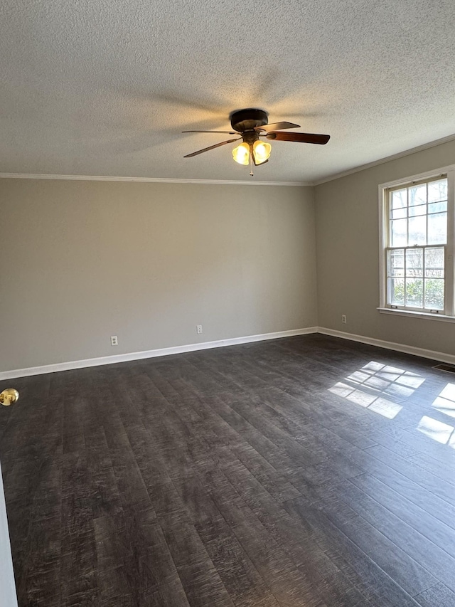 spare room with baseboards, ornamental molding, dark wood-style floors, a textured ceiling, and a ceiling fan