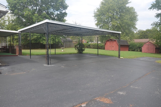 view of parking featuring a storage shed and fence