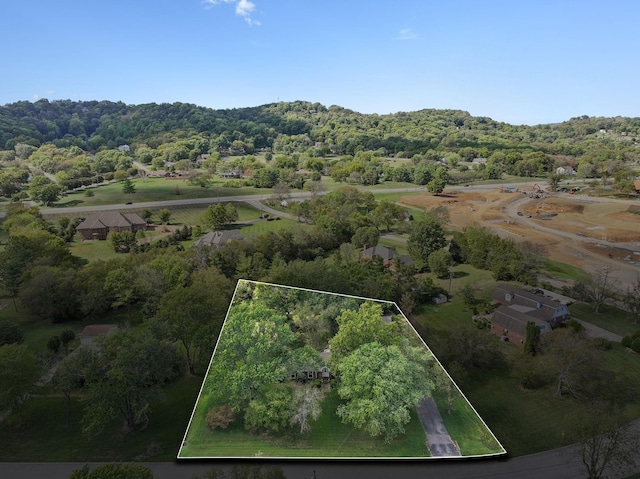 birds eye view of property featuring a wooded view