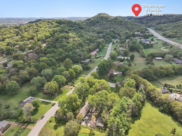 drone / aerial view featuring a view of trees