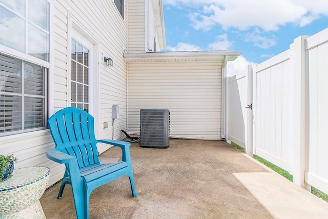 view of patio with central air condition unit and fence