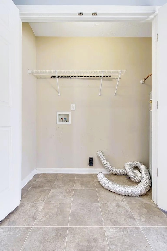 washroom featuring laundry area, hookup for a washing machine, baseboards, and tile patterned floors