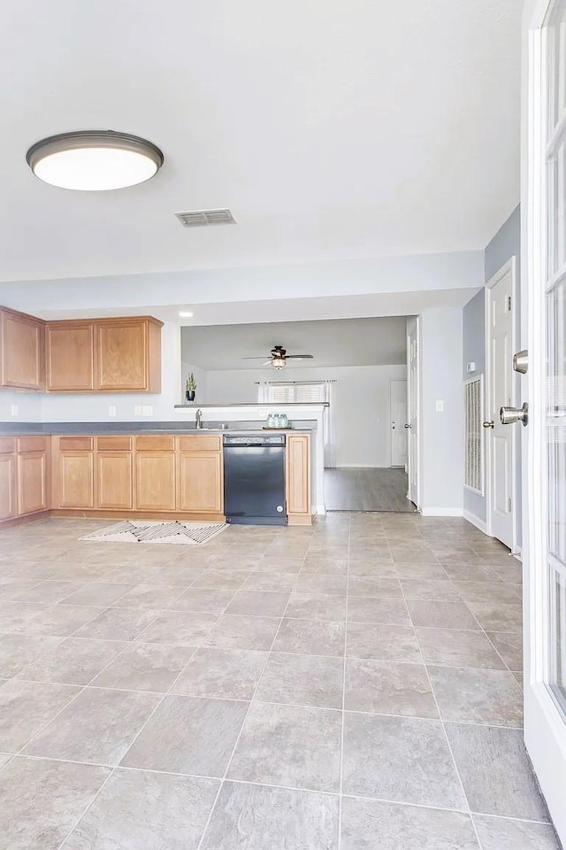 kitchen featuring visible vents, a sink, light tile patterned floors, baseboards, and dishwasher