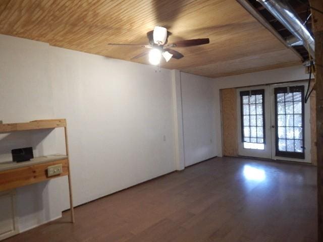 unfurnished room featuring ceiling fan, wood ceiling, and wood finished floors