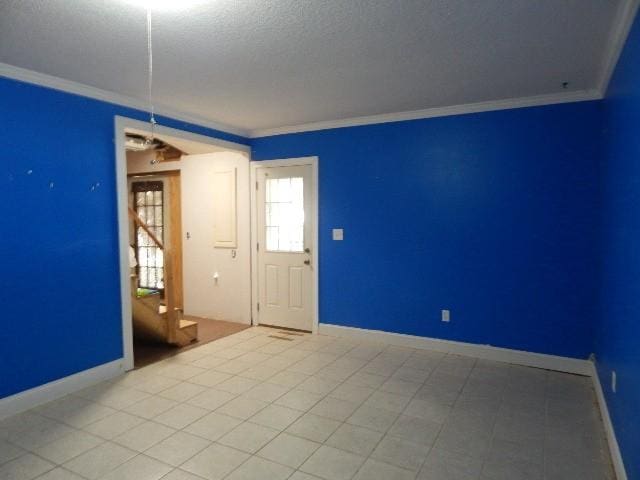 unfurnished room featuring baseboards and crown molding