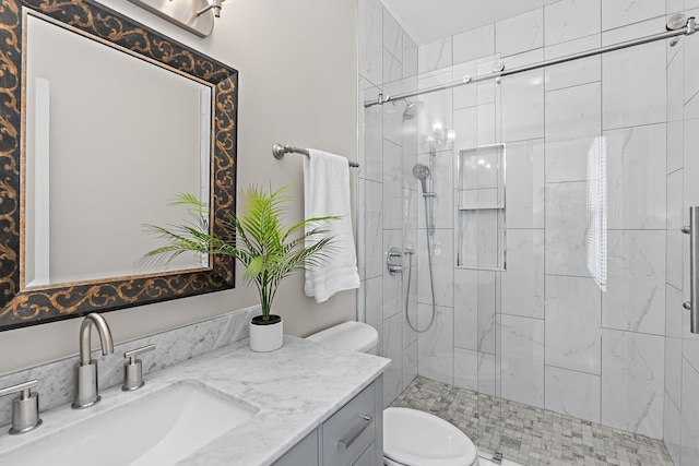 bathroom featuring a stall shower, toilet, and vanity