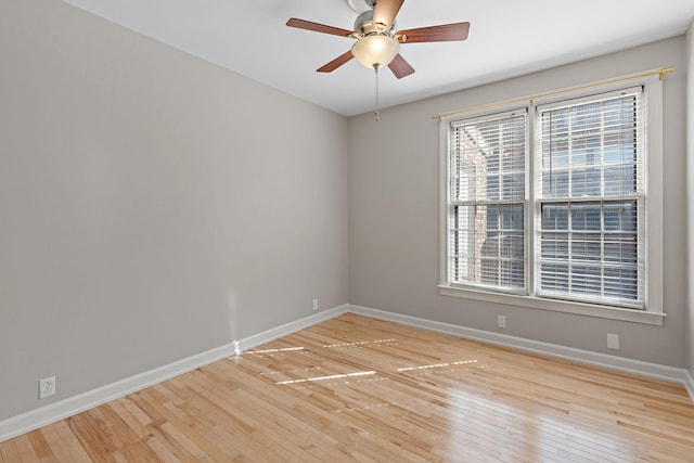 unfurnished room featuring baseboards, light wood-type flooring, and ceiling fan