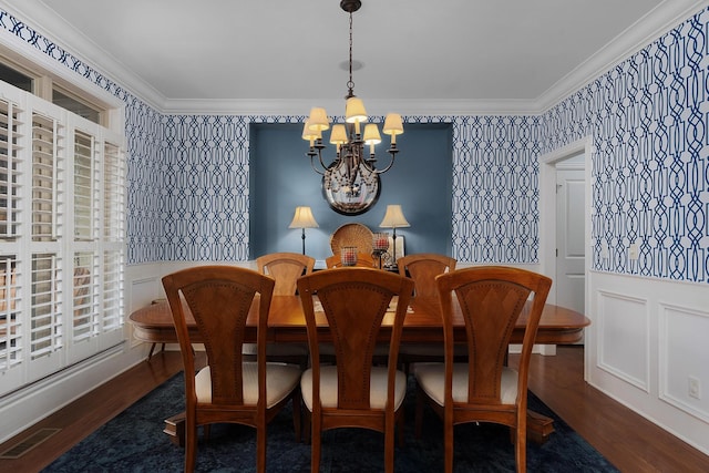 dining room with a chandelier, visible vents, wallpapered walls, and ornamental molding