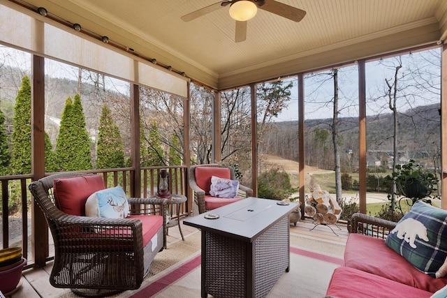 sunroom with plenty of natural light and ceiling fan