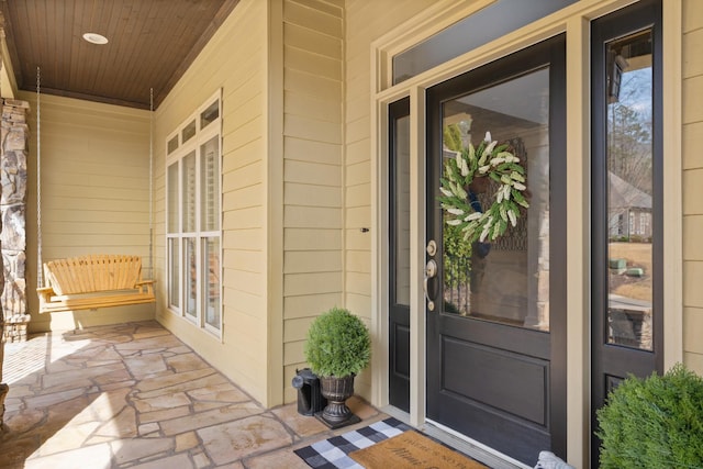 view of exterior entry with a porch