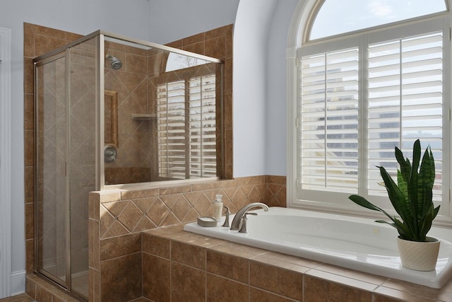 bathroom featuring a shower stall and a garden tub