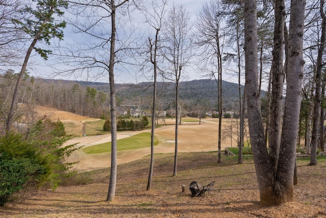 view of yard featuring view of golf course and a mountain view