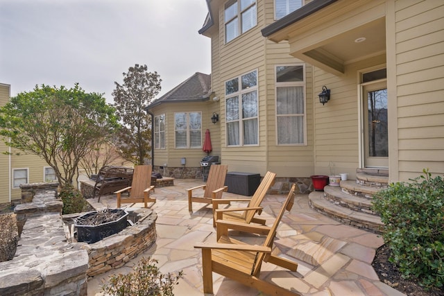 view of patio / terrace with area for grilling, entry steps, and an outdoor fire pit