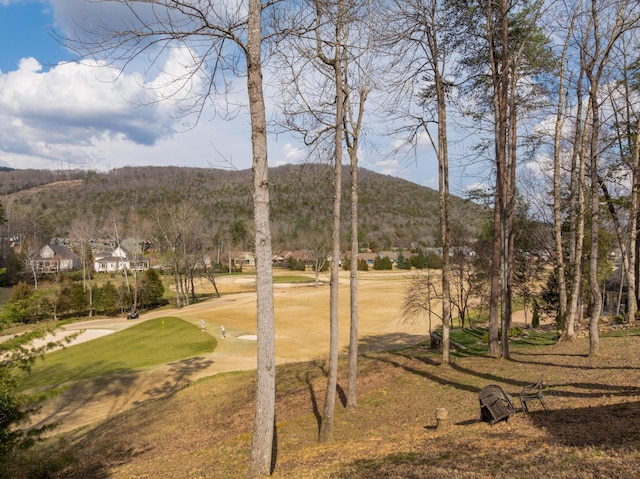 exterior space with a mountain view and view of golf course