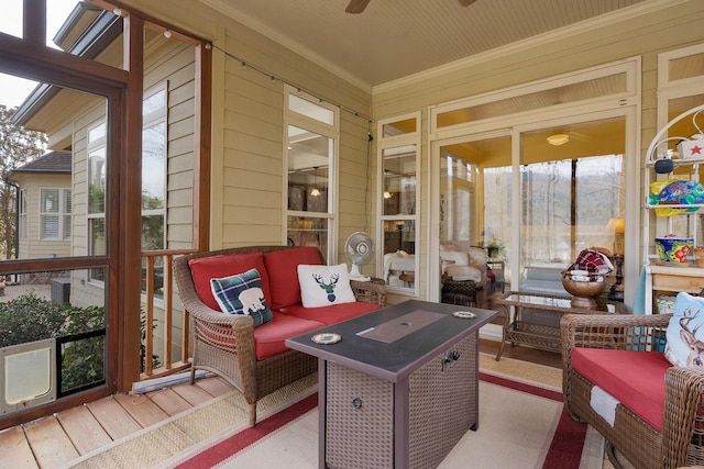 sunroom / solarium with a ceiling fan