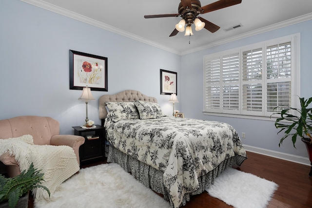 bedroom featuring visible vents, wood finished floors, crown molding, baseboards, and ceiling fan