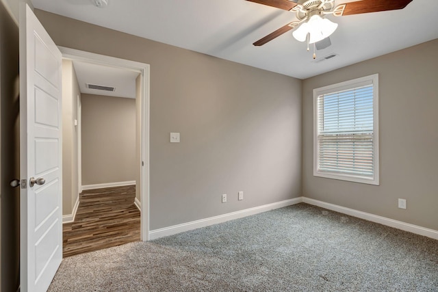 spare room featuring visible vents, carpet floors, and baseboards