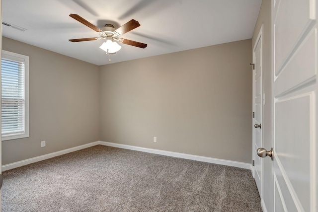 spare room featuring carpet, baseboards, and ceiling fan