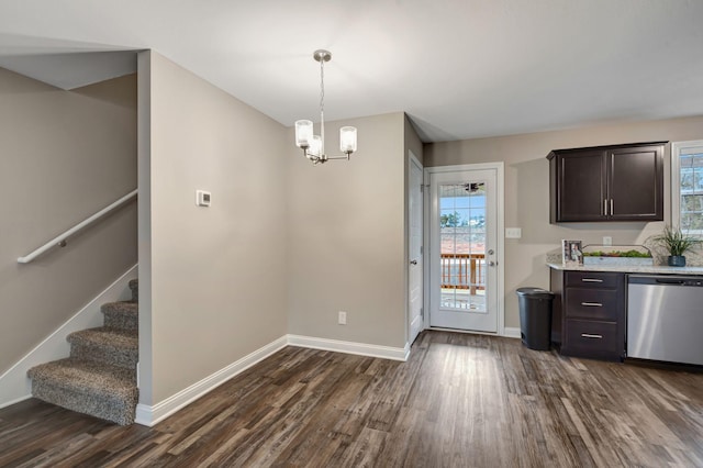 kitchen with baseboards, dark wood finished floors, dark brown cabinets, dishwasher, and a notable chandelier