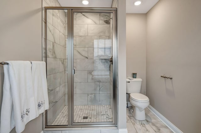 bathroom with a shower stall, toilet, recessed lighting, and baseboards