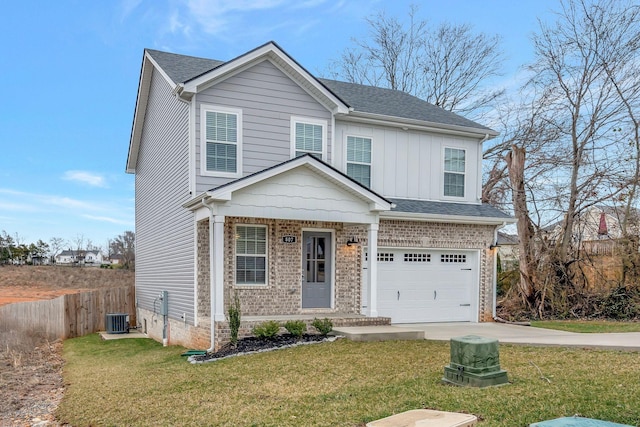 traditional-style house featuring central AC unit, fence, driveway, an attached garage, and a front lawn