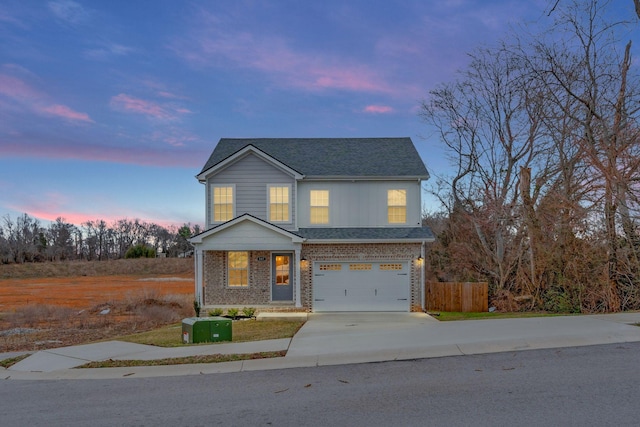 traditional-style house featuring brick siding, a shingled roof, fence, concrete driveway, and an attached garage