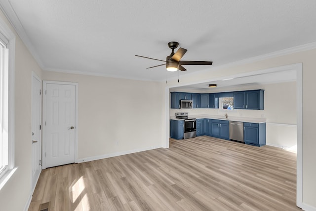 kitchen featuring blue cabinetry, ceiling fan, light wood-type flooring, light countertops, and stainless steel appliances